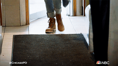 a person walking on a mat that says nbc on it