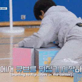 a person laying on the floor with a box that says ' starting to flip cubes in the corner ' on the bottom