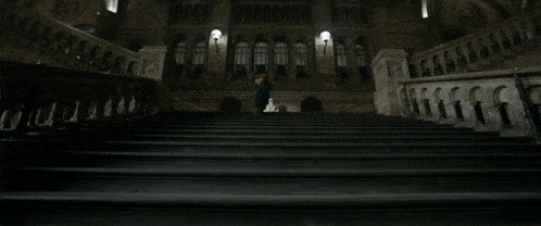 a person laying on a set of stairs in a dark room