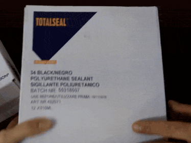 a person is holding a piece of paper that has a recycling symbol on it