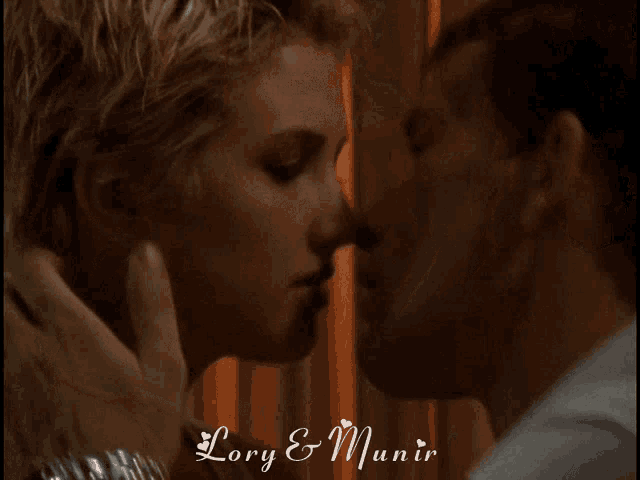 a picture of a man and woman kissing with the words lory & munir above them