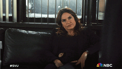 a woman is sitting on a couch with a nbc logo on the bottom