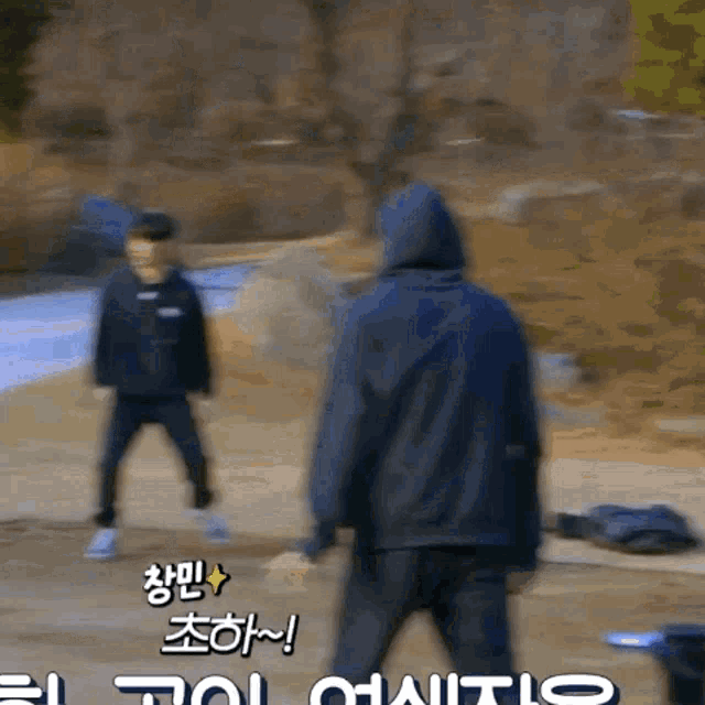 a blurry picture of a man in a hooded jacket with foreign writing