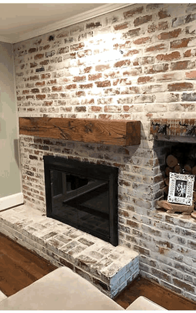 a living room with a fireplace and a picture frame on the mantle .