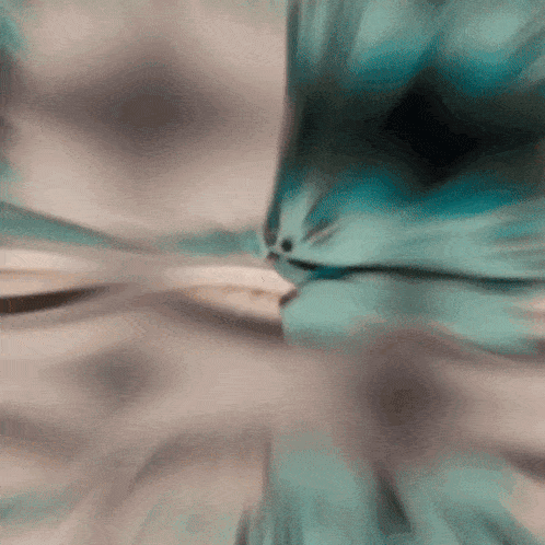 a blurred image of a person 's face with a gray and blue background