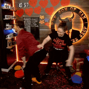 a man and a woman are dancing in front of a sign that says the son of hay