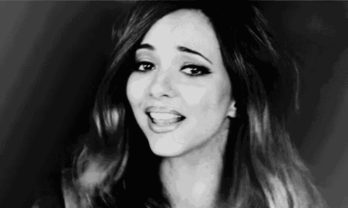 a black and white photo of a woman singing .