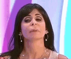 a close up of a woman 's face with a purple background