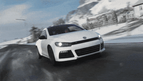a white volkswagen car is driving on a snowy road