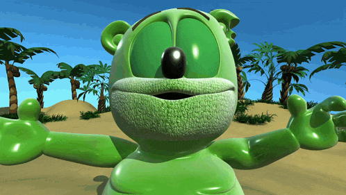a green gummy bear is standing in the desert