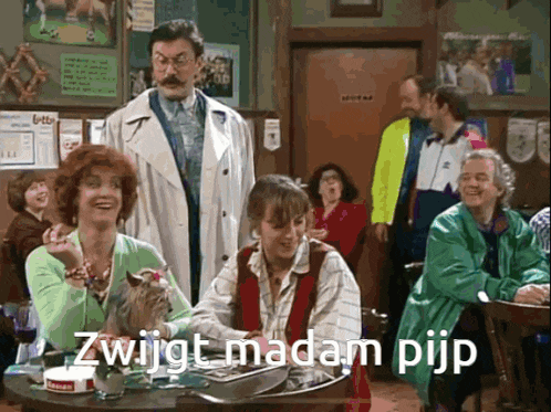 a group of people are sitting at a table and one of them says " zwijgt madam pijp "