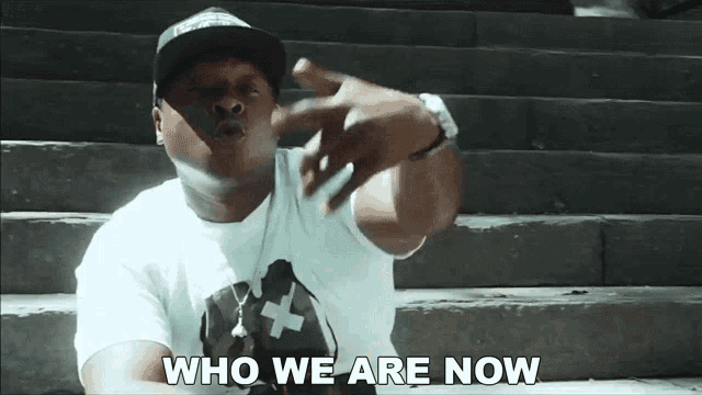a man sitting on stairs with the words " who we are now " on the bottom