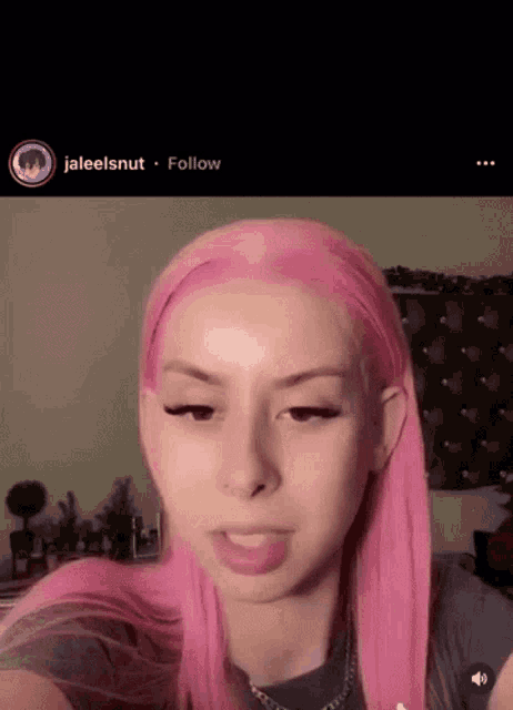 a girl with pink hair has a follow button on the bottom of the screen