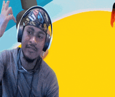 a man wearing headphones and a headband with a picture of cars on it
