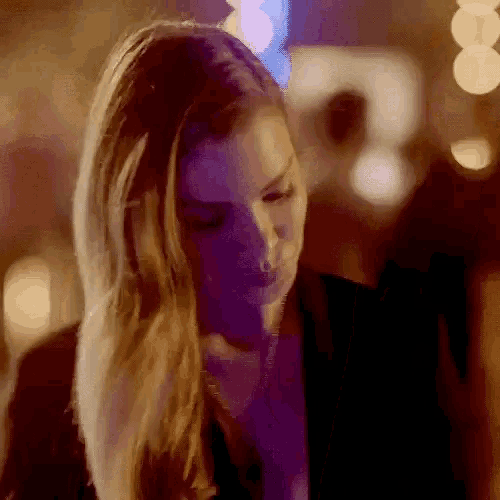 a woman with a purple light behind her