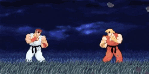two karate fighters are standing next to each other in a field .