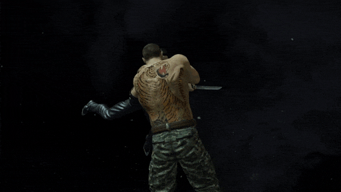 a man with a tattoo on his arm is holding a knife in his hand