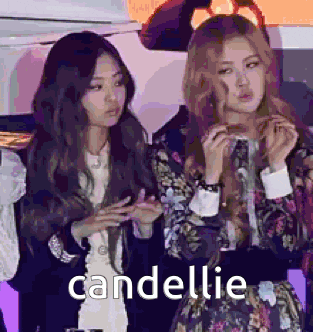 two women are standing next to each other and the word candelle is on the bottom .