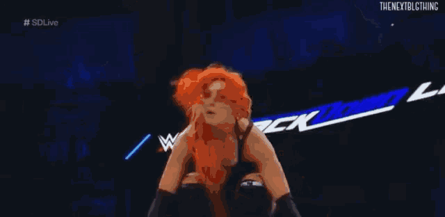 a woman is wrestling in a wrestling ring with a referee .