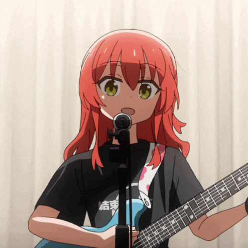 a girl with red hair is singing into a microphone while playing a guitar