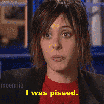 a woman in a red shirt and black jacket says i was pissed .