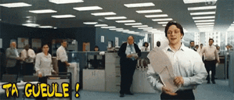 a man holding a piece of paper in an office with the words ta gueule written above him
