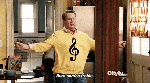 a man in a yellow sweater with a treble clef on it