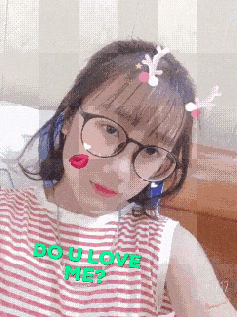 a girl is wearing glasses and a shirt that says do u love me