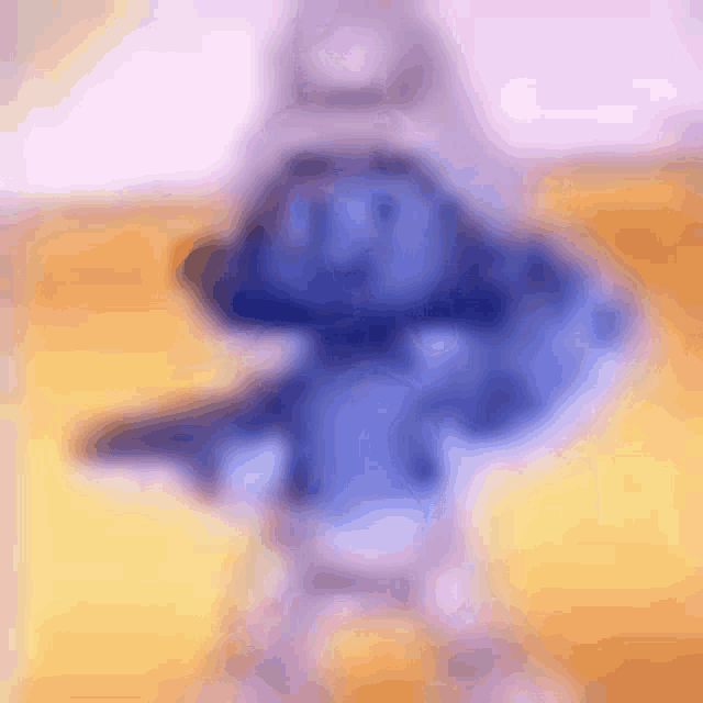 a blurred image of a smurf holding a gun on a table .