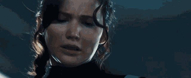 a close up of a woman 's face with tears coming out of her eyes
