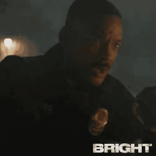 a close up of a man 's face in a dark room with the word bright in the corner .