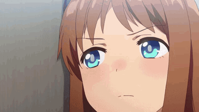 a close up of a girl 's face with blue eyes