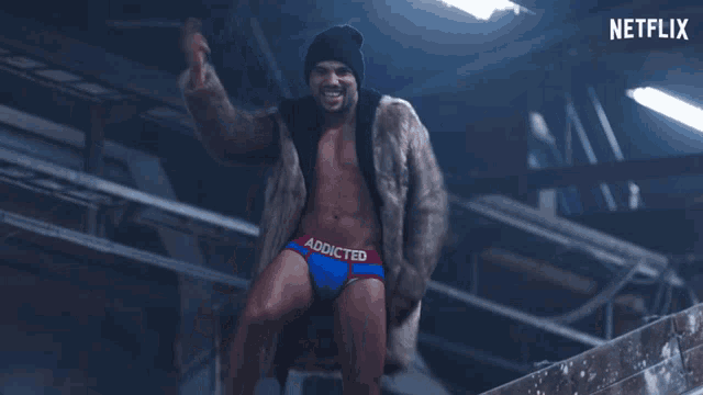 a man in a fur coat and underwear with addicted written on it
