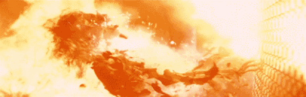 a person is flying through the air in front of a large explosion .