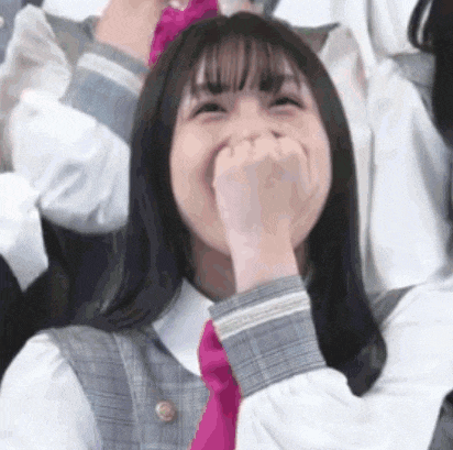 a girl in a plaid shirt and pink tie is laughing .