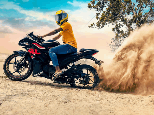 a person riding a suzuki motorcycle in the dirt