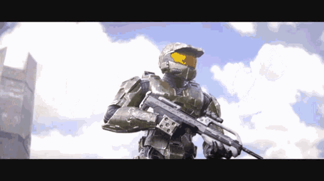 a man in a green helmet holding a gun