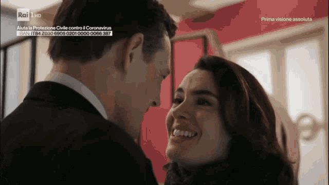 a man and a woman are looking into each other 's eyes with the words prima visione assoluta on the bottom