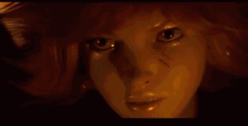 a close up of a woman 's face with a shadow on it .