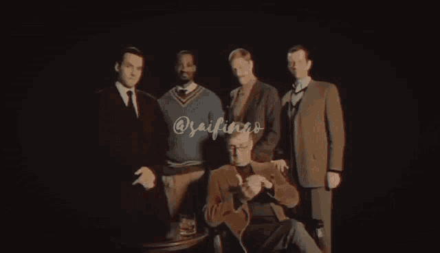 a group of men are posing for a picture with the name saifingo on the bottom left