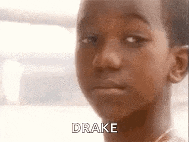 a close up of a young boy 's face with the word drake written on the bottom .