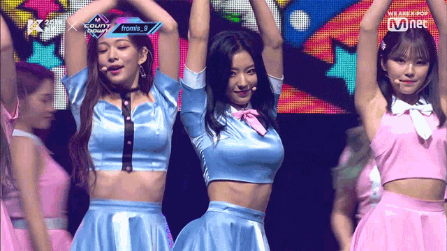 a group of girls are performing on a stage with the words " we are kpop " on the bottom right