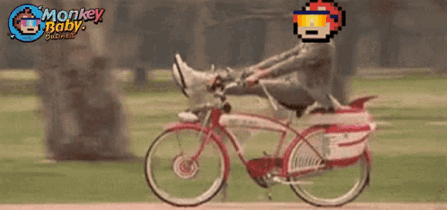 a man is riding a bike with monkey baby written on the bottom