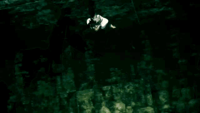 an aerial view of a person hanging from a rope