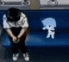a person is sitting on a blue couch with a shadow of a man on it .