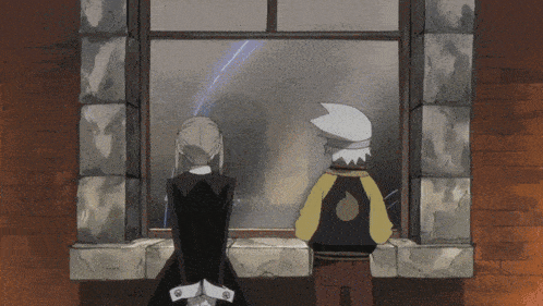 a man and a woman are looking out a window