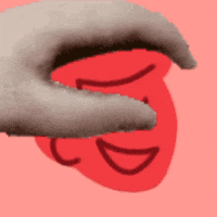 a hand is holding a red heart with a smile drawn on it