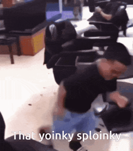 a man in a black shirt is dancing in a room with the words that yoinky sploinky