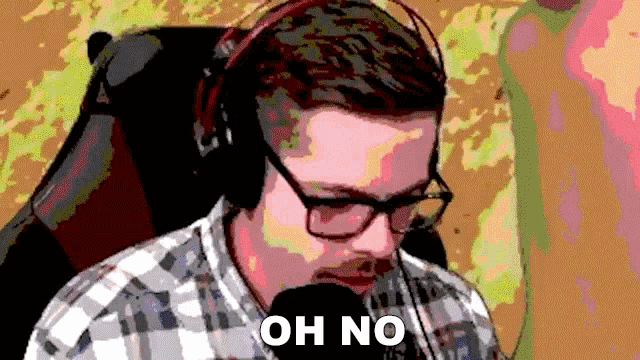 a man wearing headphones and glasses says " oh no "
