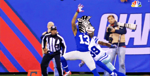 a football player with the number 13 on his jersey is being tackled